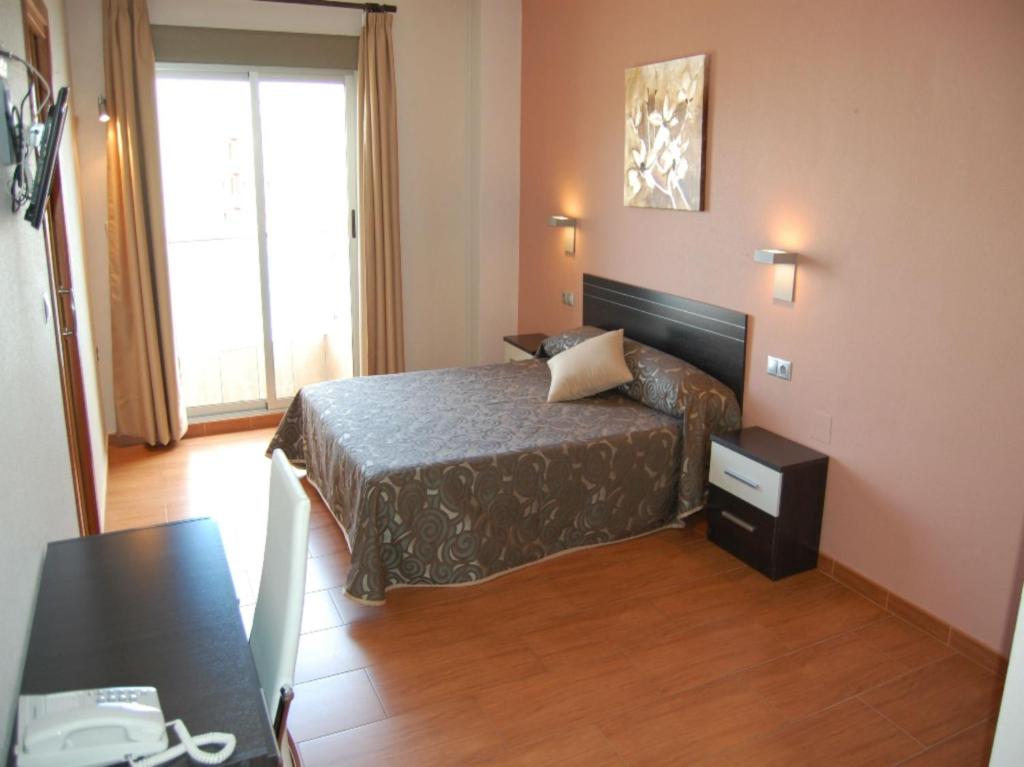 Postel nebo postele na pokoji v ubytování Hotel Almoradi