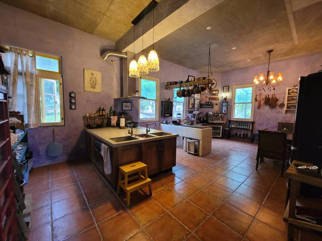 a large kitchen with a sink and a counter at MIRAMONTI House 賣房間更賣生活 in Xikou