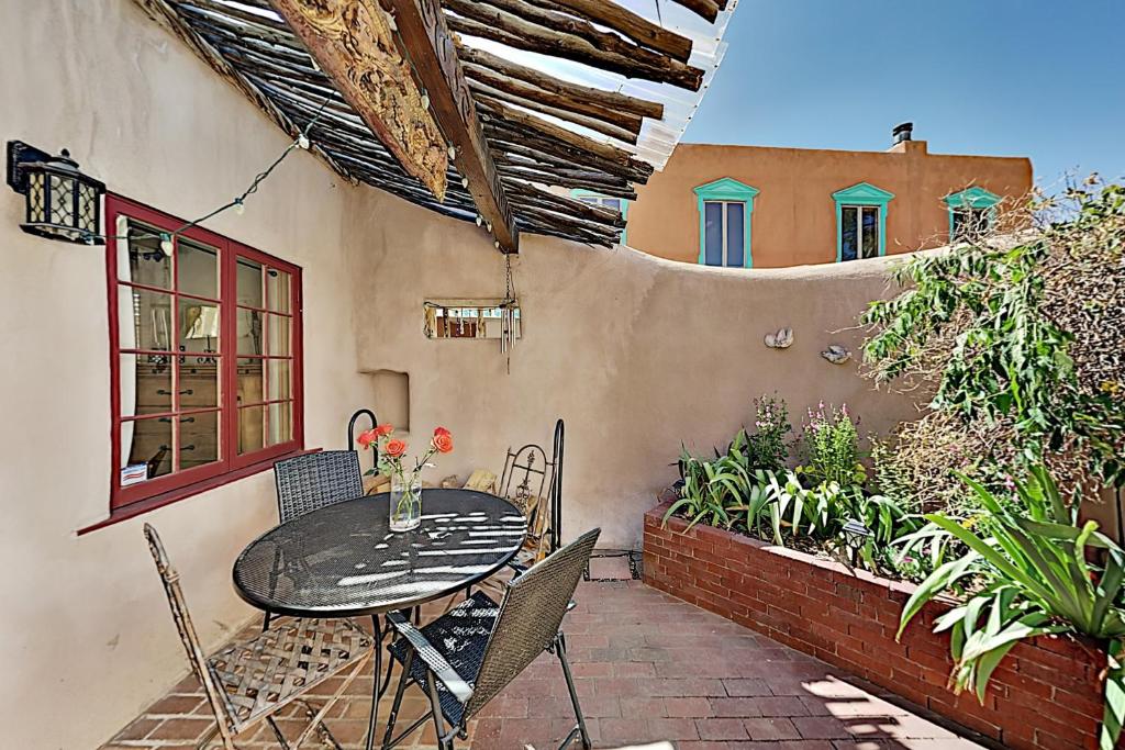 a patio with a table and chairs and a building at Reposada Unit 1 in Santa Fe