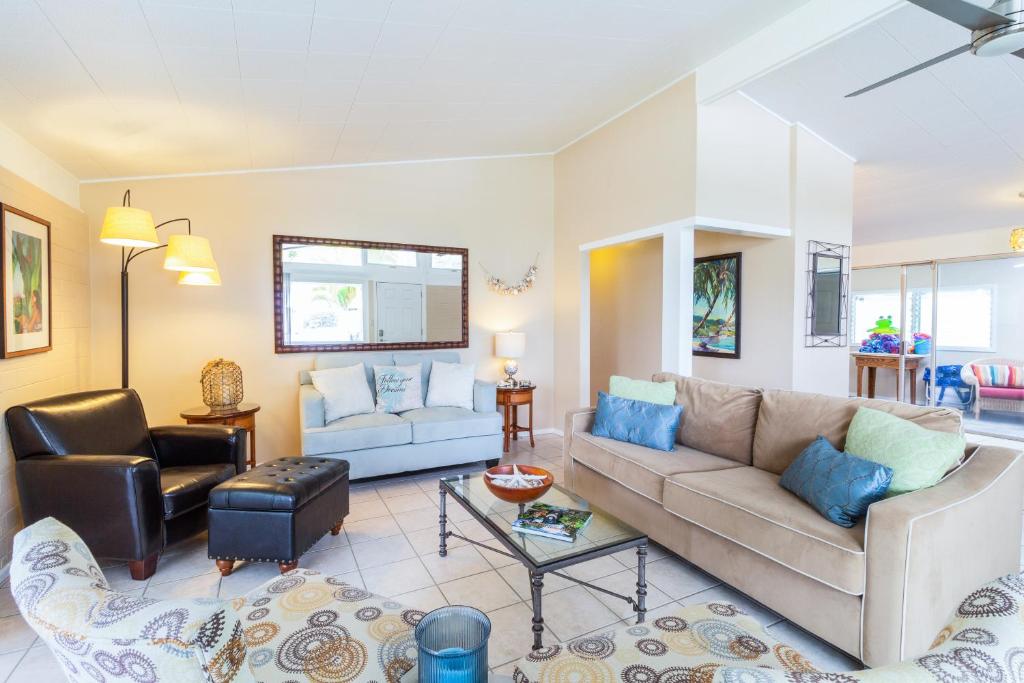 a living room with a couch and a chair at Kaiwiki Palace in Honolulu