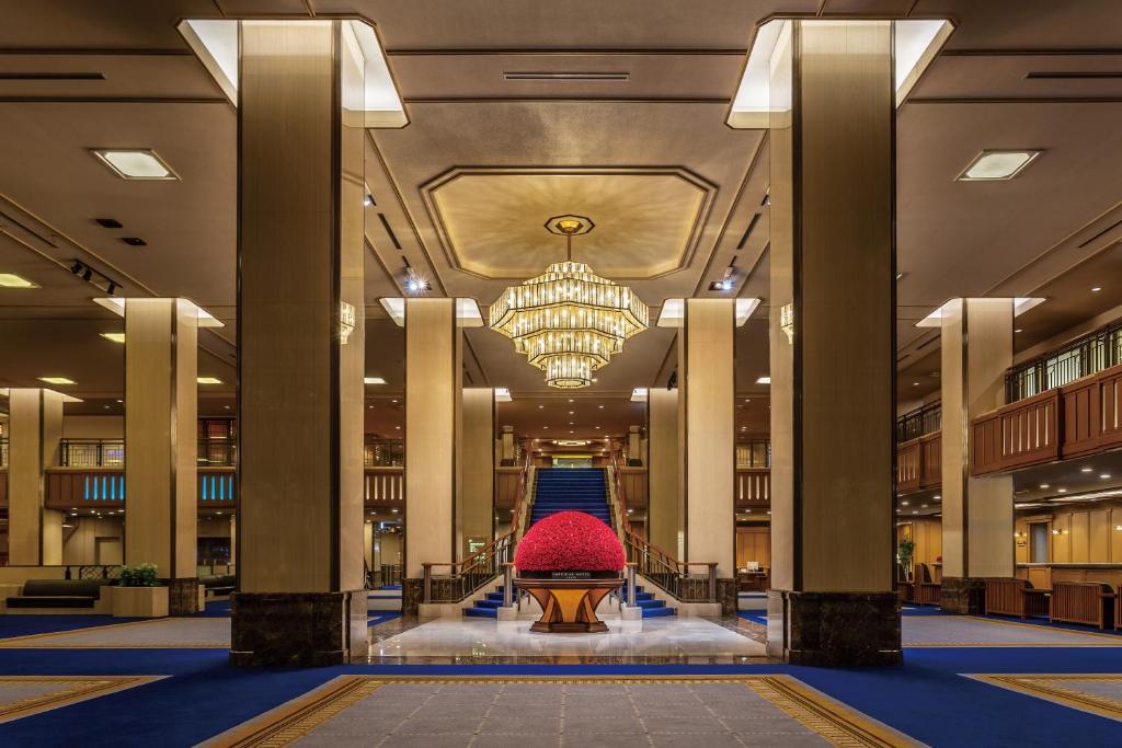 a lobby with a chandelier and a staircase in a building at Imperial Hotel Tokyo in Tokyo