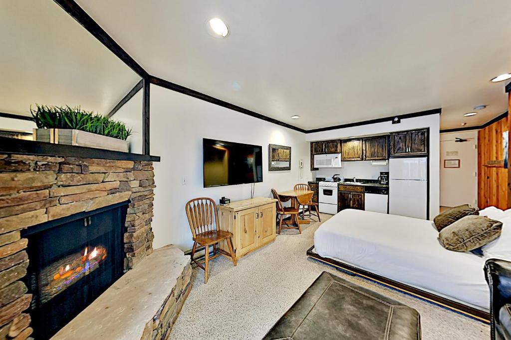 Mountain Village Lodge 221 في بارك سيتي: غرفة نوم بسرير ومدفأة