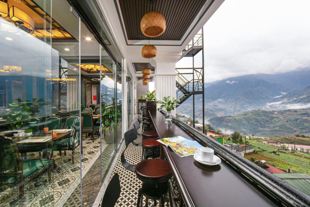 a restaurant with a view of the mountains at DeLaSol Sapa Hotel in Sa Pa
