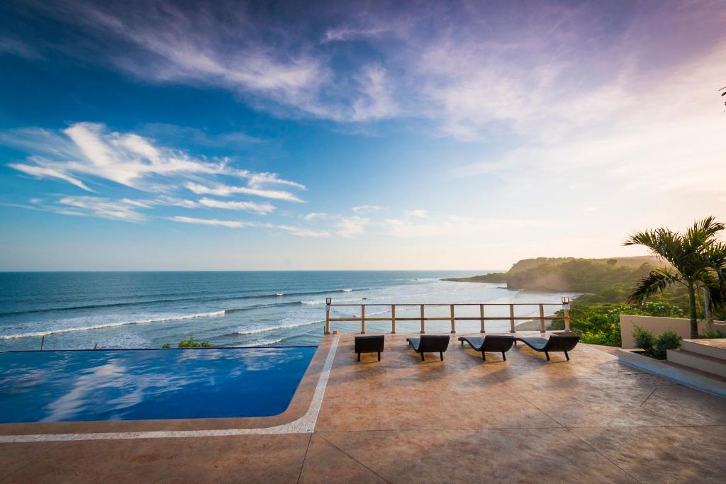 a view of the ocean from the balcony of a resort at Hotel Los Mangos El Salvador in El Cuco