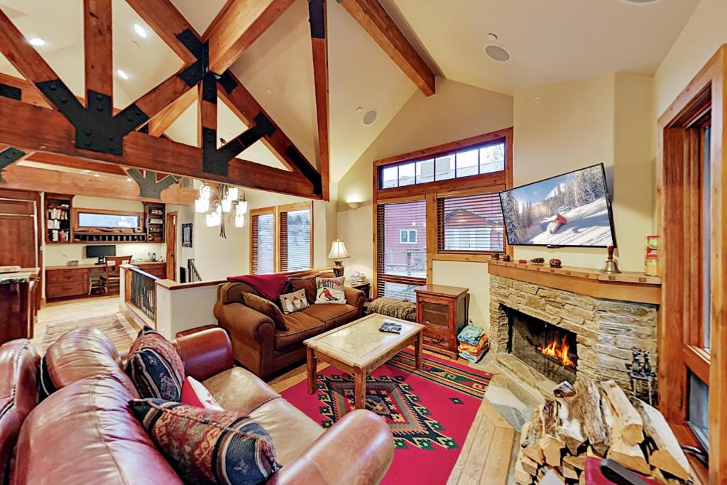 a living room with a couch and a fireplace at Quittin' Time on the Woodside in Park City