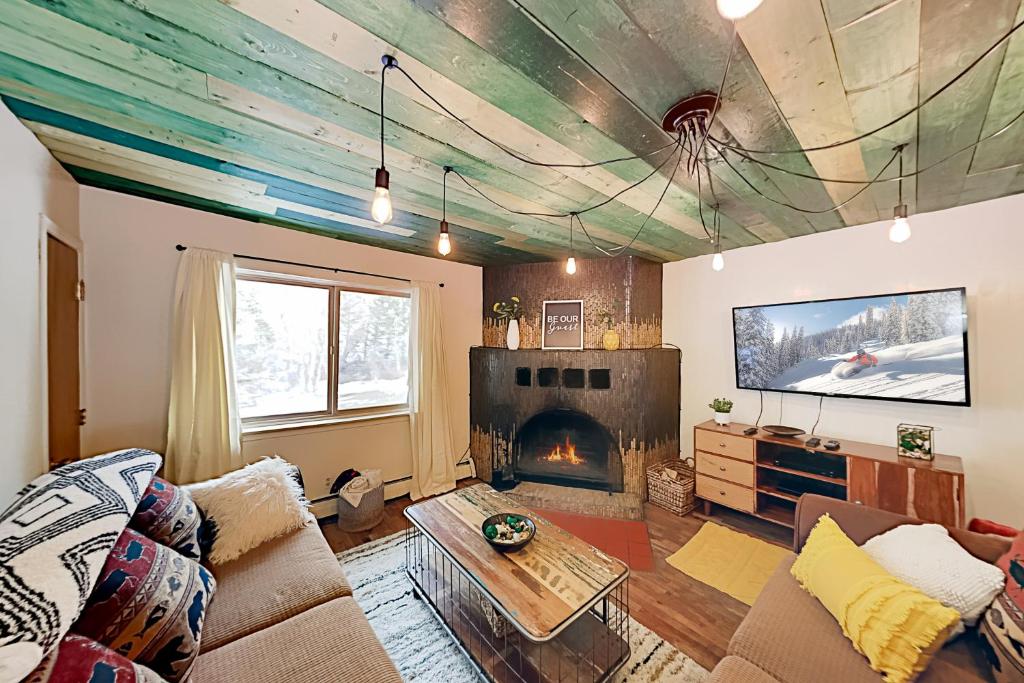 a living room with a couch and a fireplace at Mountain Escape in Taos Ski Valley