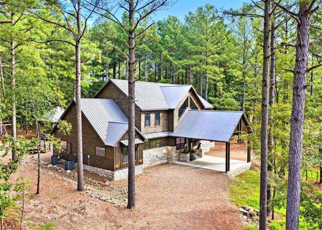 a home in the woods with a gambrel roof at Lazy Dog in Stephens Gap