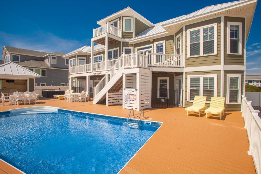 a large house with a swimming pool in front of it at Count Your Blessings in Virginia Beach