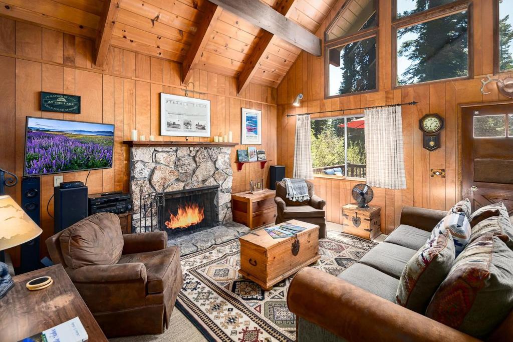 a living room with a couch and a fireplace at The Honey Bear Cabin in Carnelian Bay