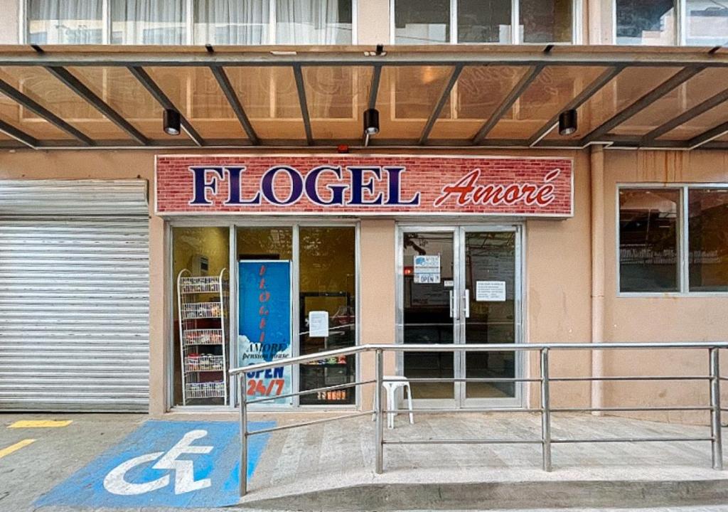 a grocery store with a sign on the front of it at Flogel Amore Pension House in Cebu City