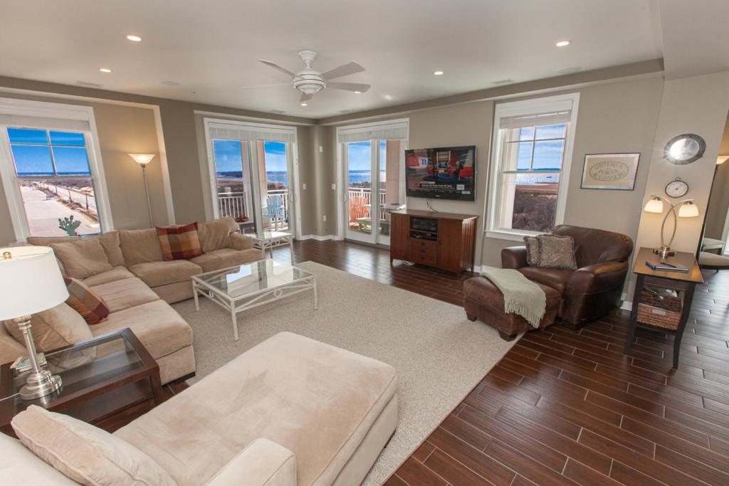 a living room with a couch and a table at The Sanctuary - Beach and Bay Penthouse B428 in Virginia Beach