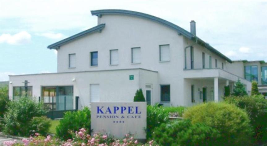 a large white house with a sign in front of it at Pension Kappel in Ried im Innkreis