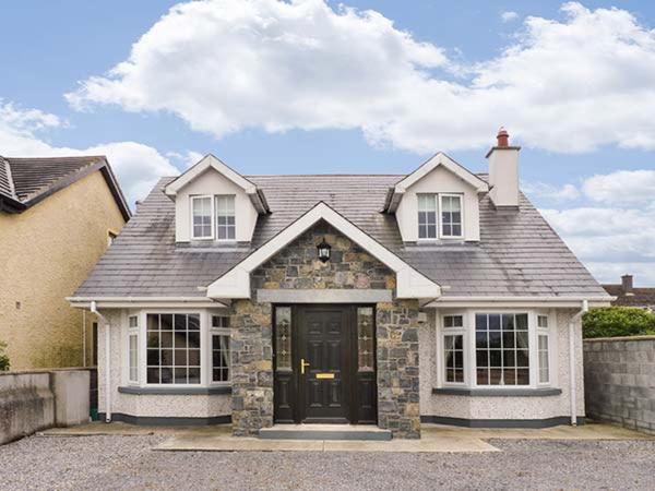 a large house with a black door on a street at Lovers' Lodge in Kilkenny