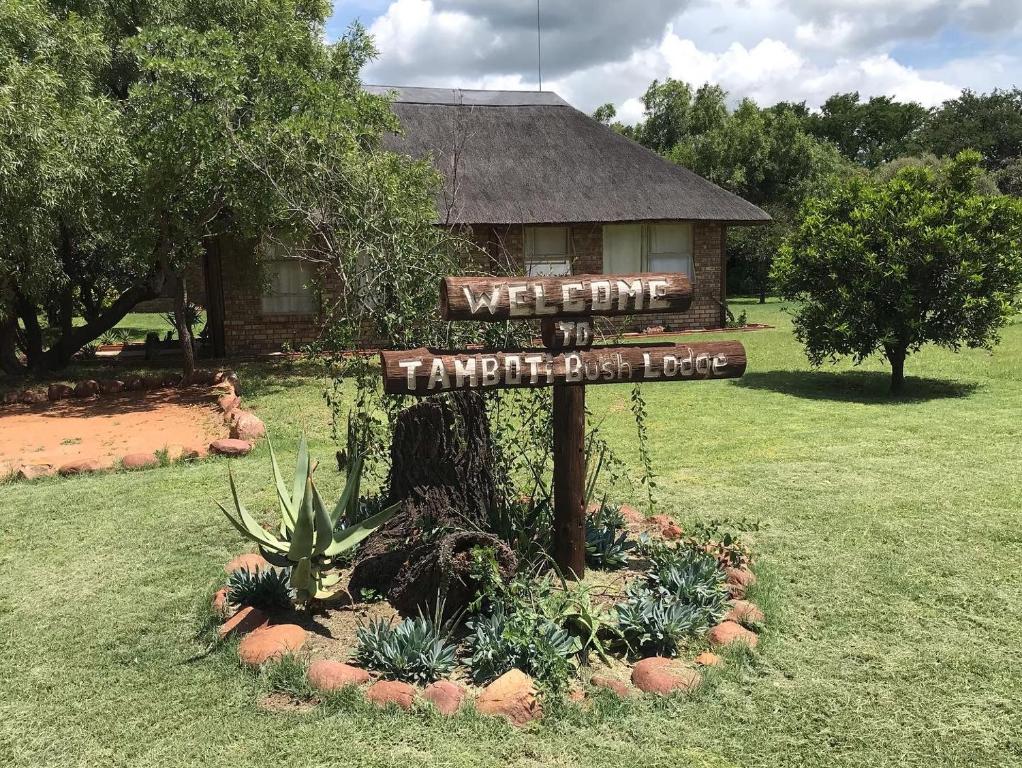 a sign in a yard in front of a house at Tamboti Bush Lodge in Hammanskraal