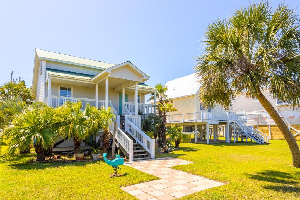 a house with palm trees in front of it at 21 Palms in Gulf Shores