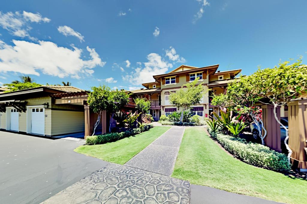 a house with a green lawn in front of it at Halii Kai 18E - Waikoloa in Waikoloa