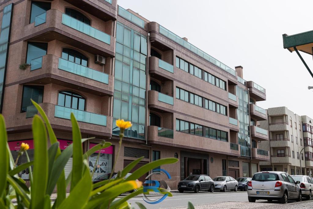a building with cars parked in front of it at RAFURADOURO in Ovar