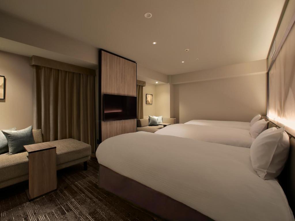 Postel nebo postele na pokoji v ubytování ORIENTAL HOTEL UNIVERSAL CITY