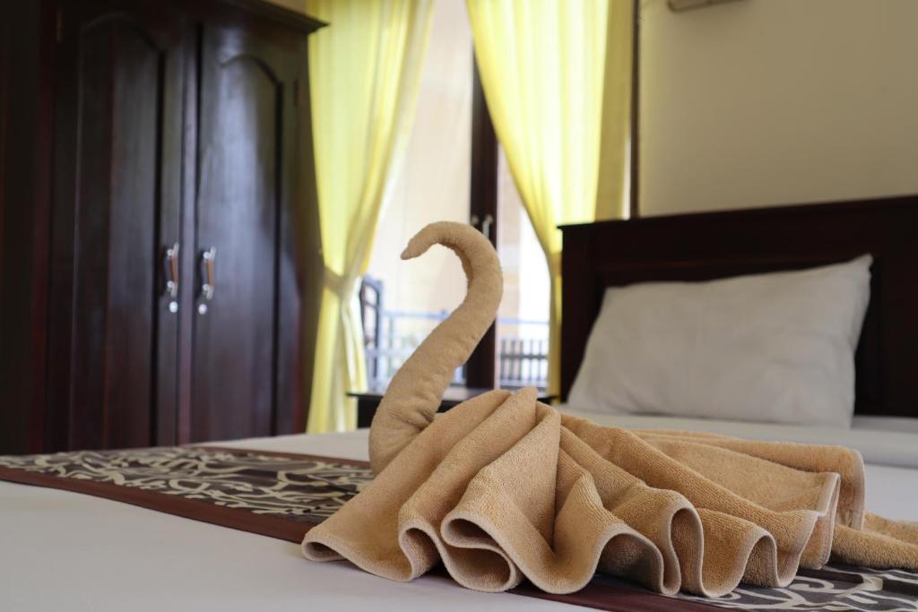 Postel nebo postele na pokoji v ubytování Wijaya Guest House Ubud