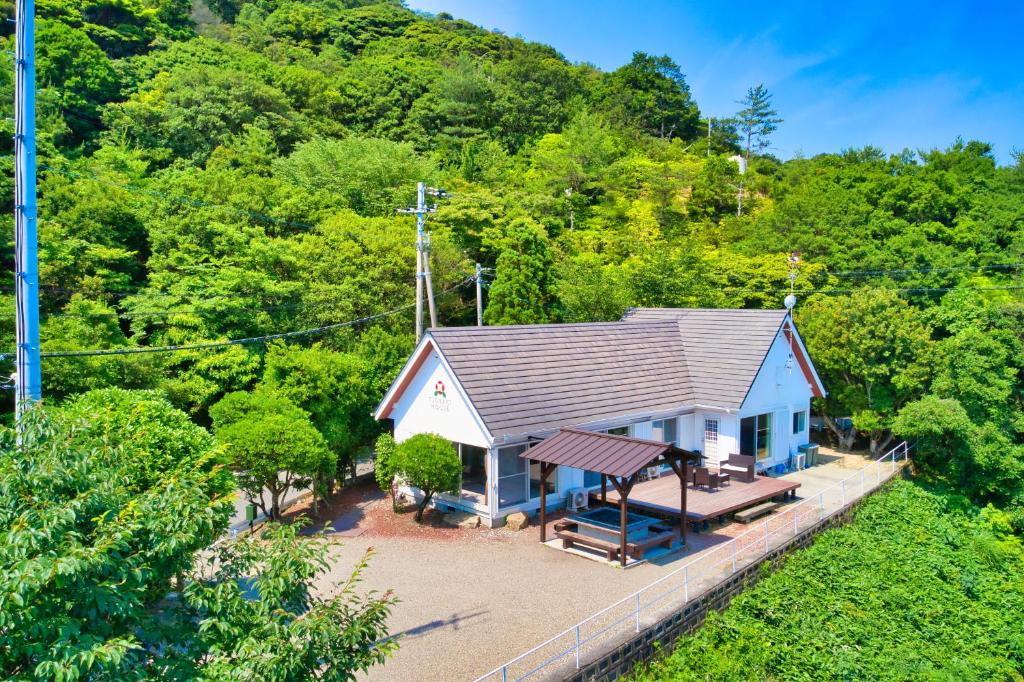 an overhead view of a small house in the woods at Tsubaki House in Anan