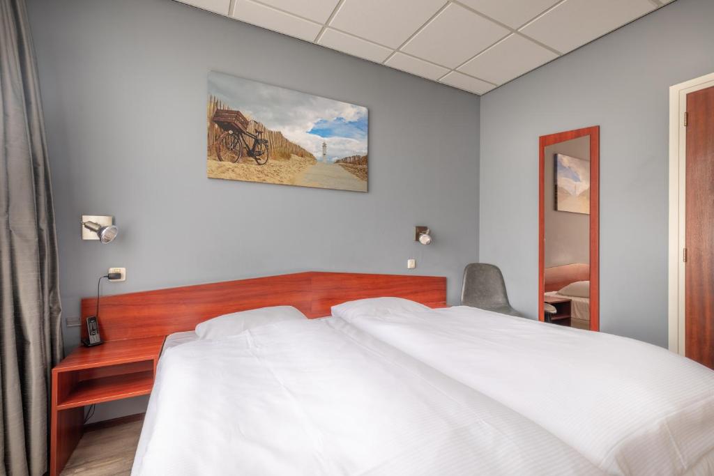 Postel nebo postele na pokoji v ubytování Two Brothers Hotel Astoria