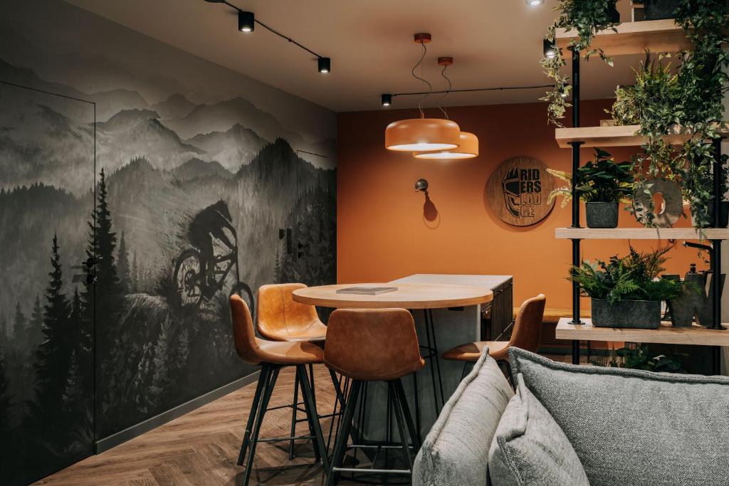 a dining room with a table and chairs at Apartament Riders Lodge Bielsko-Biała Jeżynowa in Bielsko-Biała