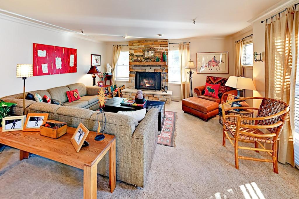 a living room with a couch and a table at Park Ave Manor 3B in Park City