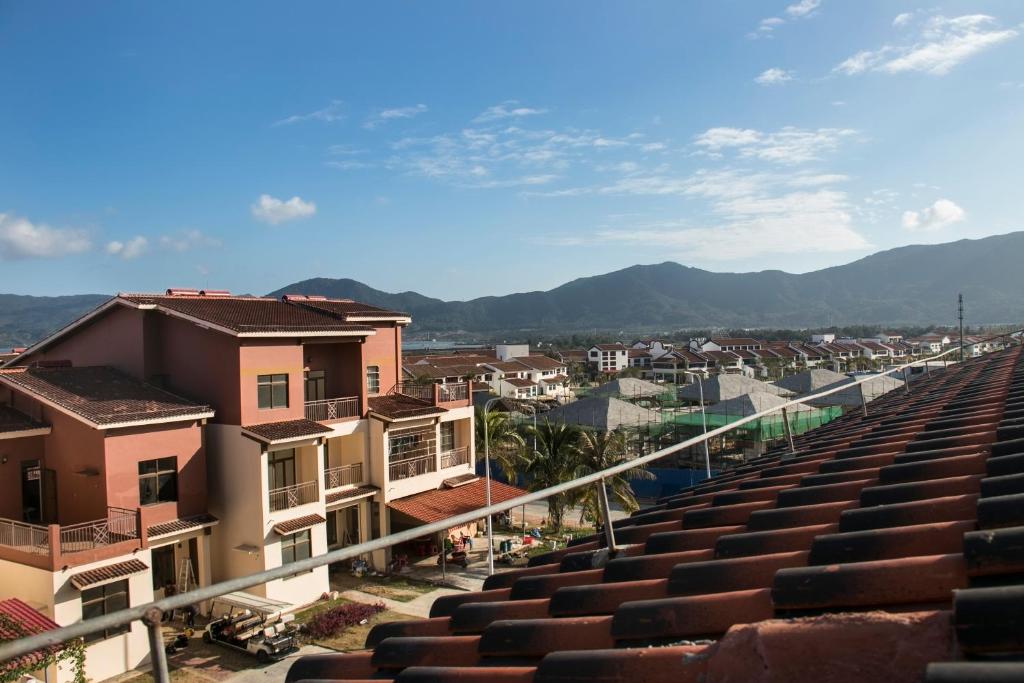 a view of a city with houses and mountains at Sanya Haitangwan Shang Gong Yuan She Wellness Resort Villa in Sanya