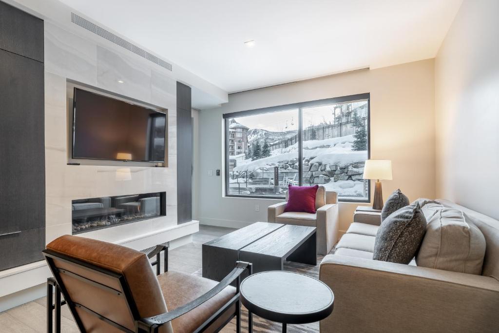 a living room with a couch and a fireplace at The Lift 309 in Park City