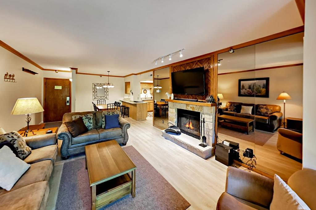 a living room filled with furniture and a fireplace at Park Station Condominiums 234 in Park City
