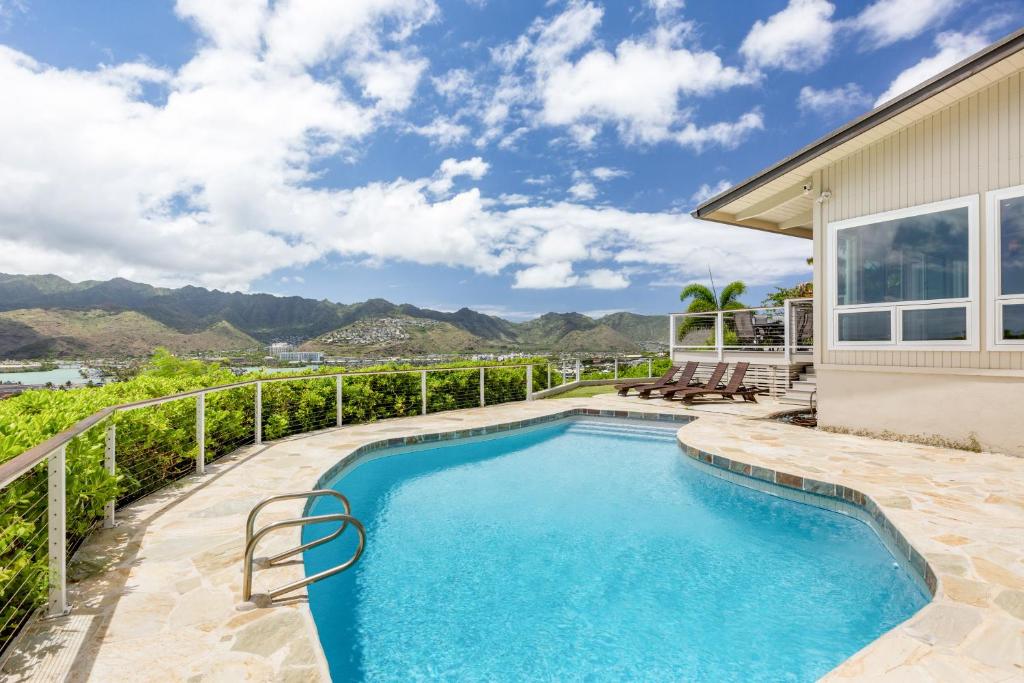 a swimming pool in the backyard of a house at Hale Maunalua in Honolulu