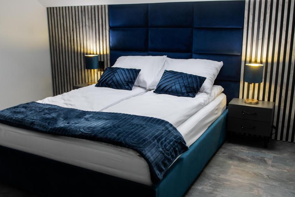 A bed or beds in a room at Apartamenty ASLux - Noclegi Energylandia Zator