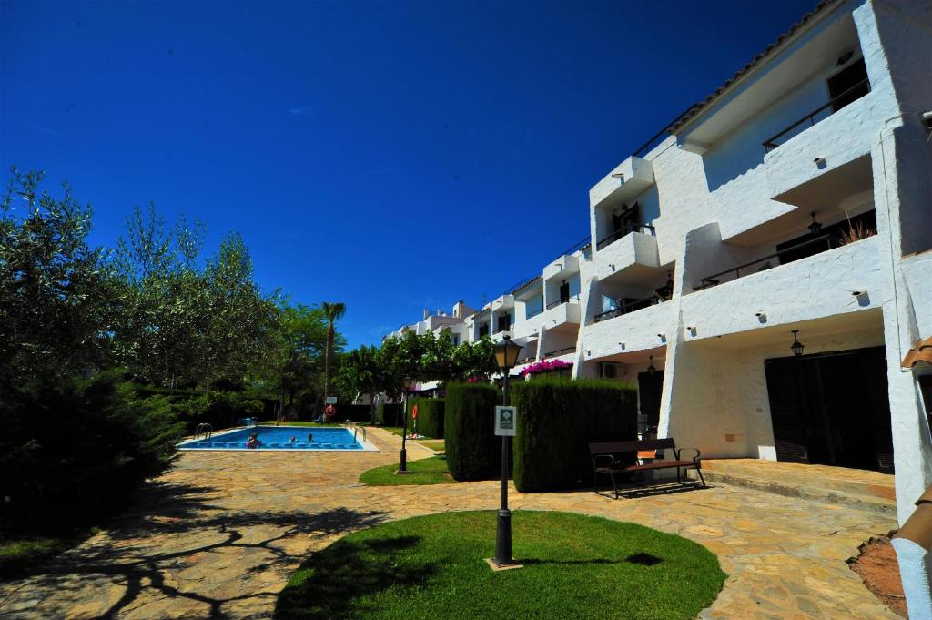 a building with a swimming pool next to a building at Orange Park Duplex Atico Vista Piscina in Benicàssim