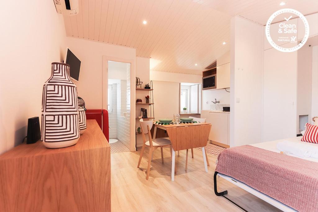 リスボンにあるAlfama Suite by Homingのベッドルーム1室(ベッド1台付)、ダイニングルームが備わります。