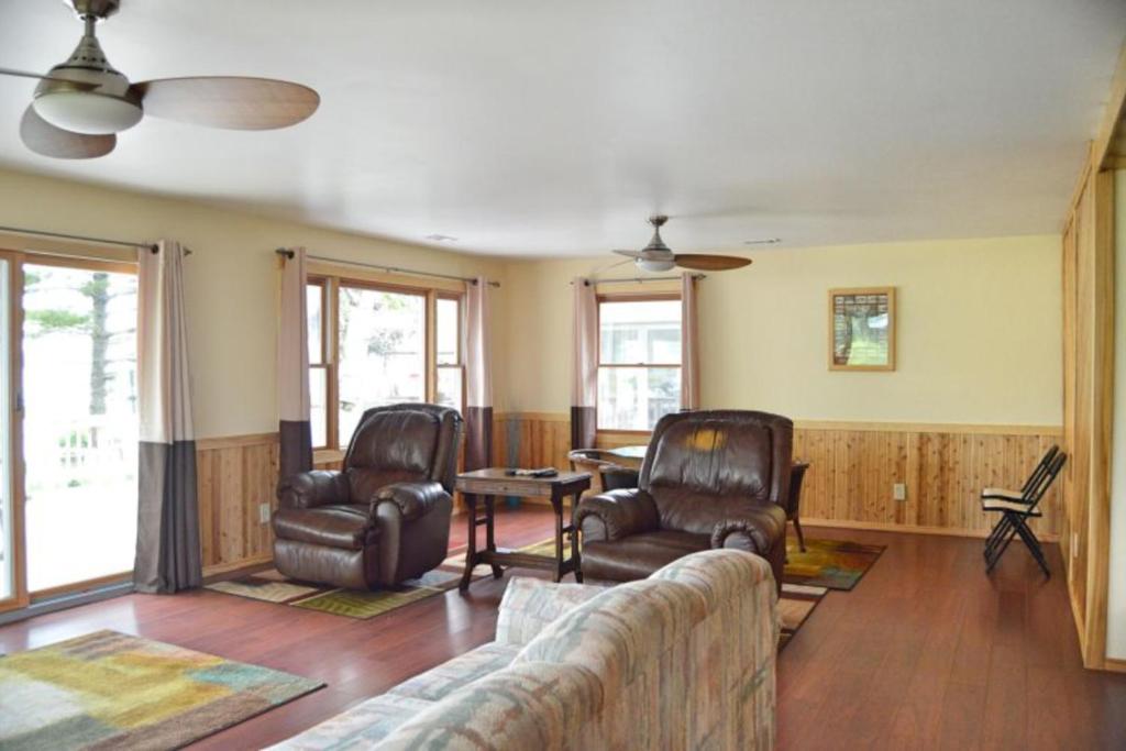 a living room with two chairs and a couch at The Summer House in Onekama