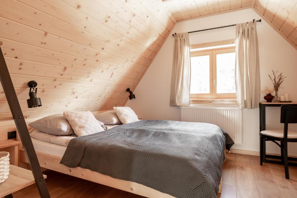 a bedroom with a bed in a wooden attic at Dolina in Zakopane