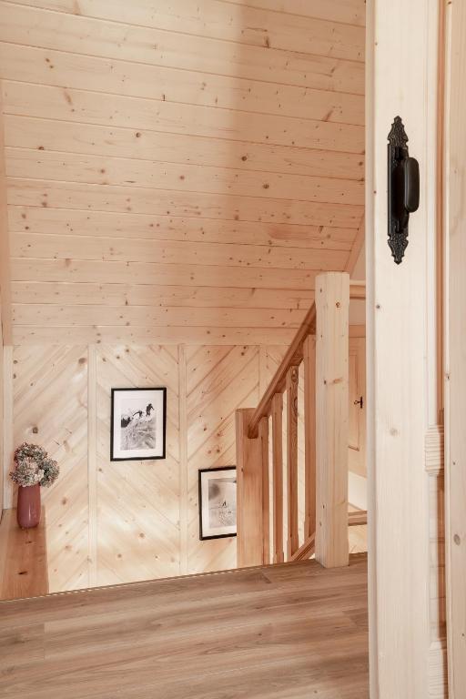 a staircase in a log cabin with wooden walls at Dolina in Zakopane