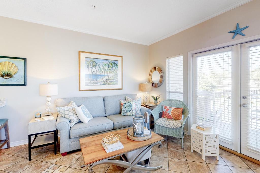 a living room with a couch and a table at Caribbean Dunes #226 in Destin