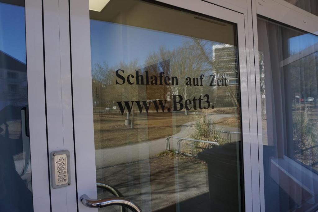 a sign on the glass door of a building at Bett3de in Erding