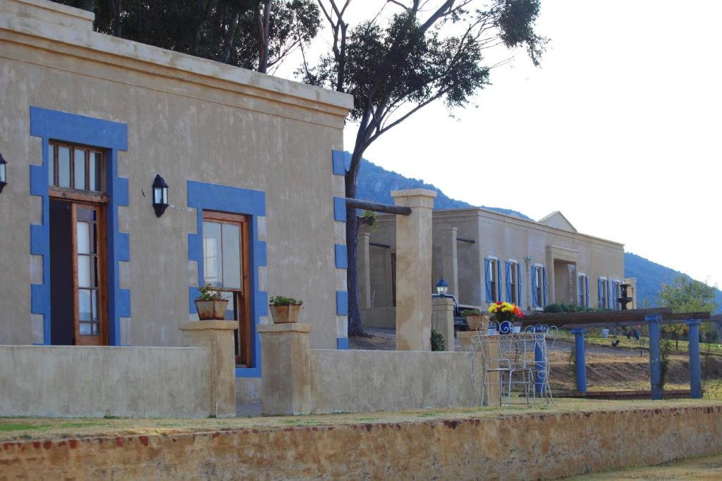 a row of houses with blue paint on them at Keurfontein Country House in Willowmore