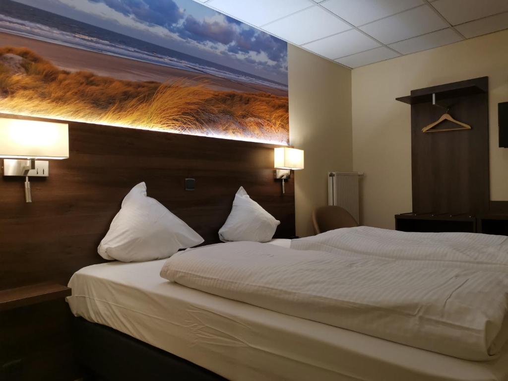 a bedroom with a bed with a painting on the wall at Hotel Albert II Oostende in Ostend