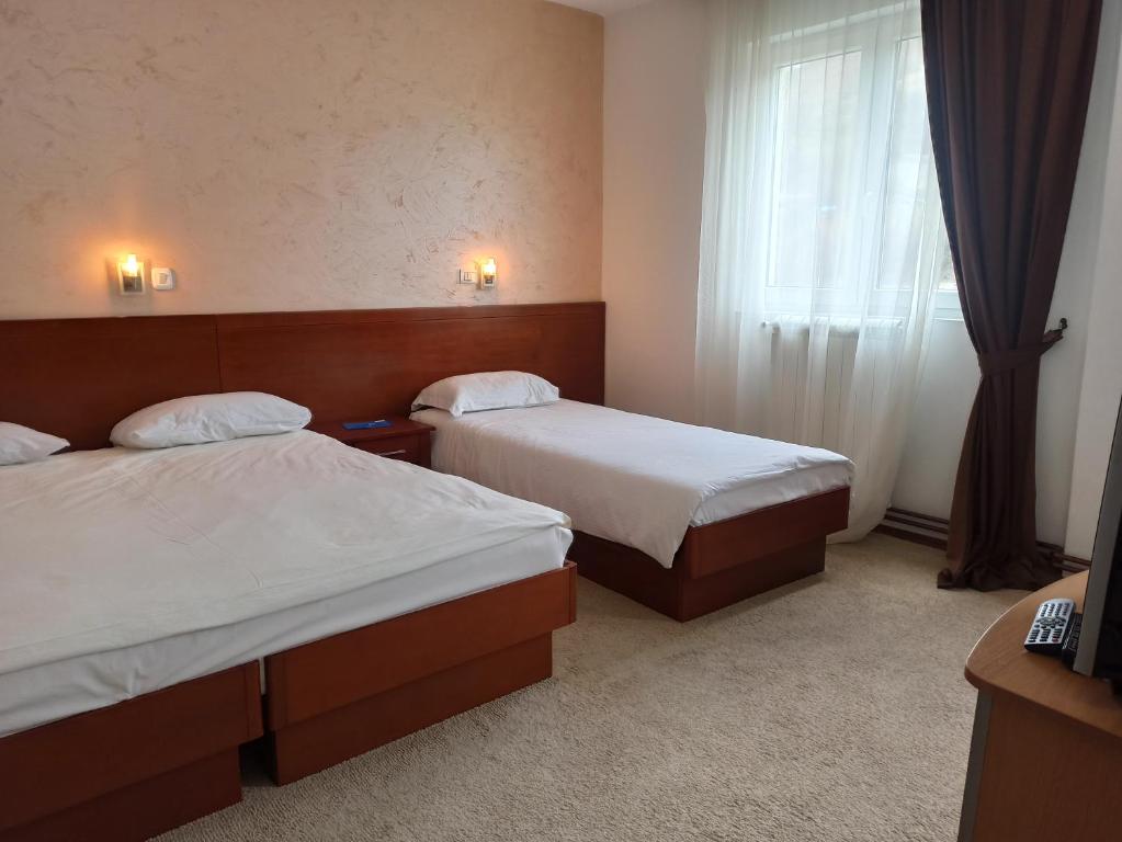 Postel nebo postele na pokoji v ubytování Hotel Dominus