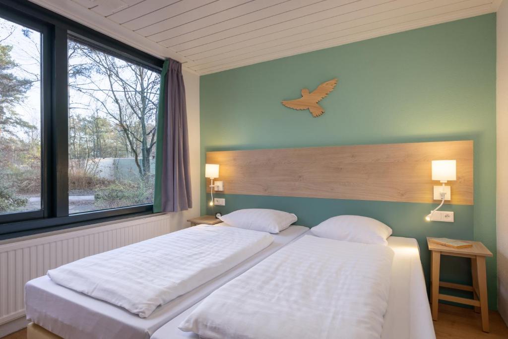 Postel nebo postele na pokoji v ubytování Center Parcs Vossemeren