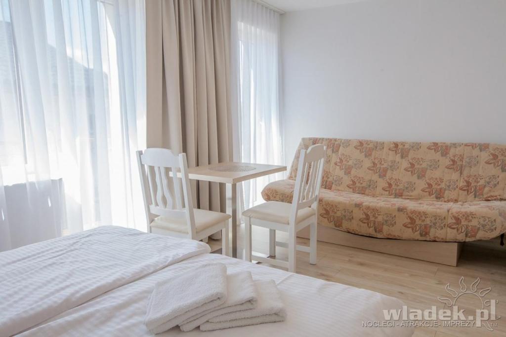 Postel nebo postele na pokoji v ubytování Willa Promyk