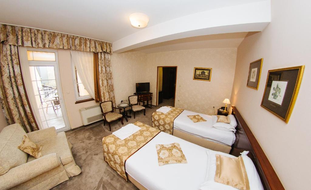 Postel nebo postele na pokoji v ubytování Garni Hotel Andric