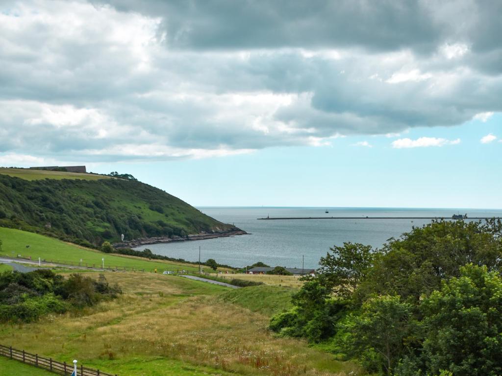 a view of the ocean from a hill at Vintage Showman's Wagon For Two Close to Beach in Plymouth