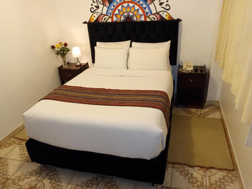 Ein Bett oder Betten in einem Zimmer der Unterkunft Inkas Land