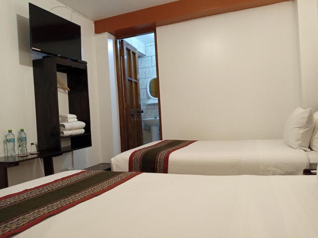 Ein Bett oder Betten in einem Zimmer der Unterkunft Inkas Land