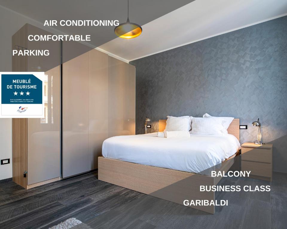 a bedroom with a bed with white pillows at Garibaldi Acropolis, emplacement idéal, parking in Nice