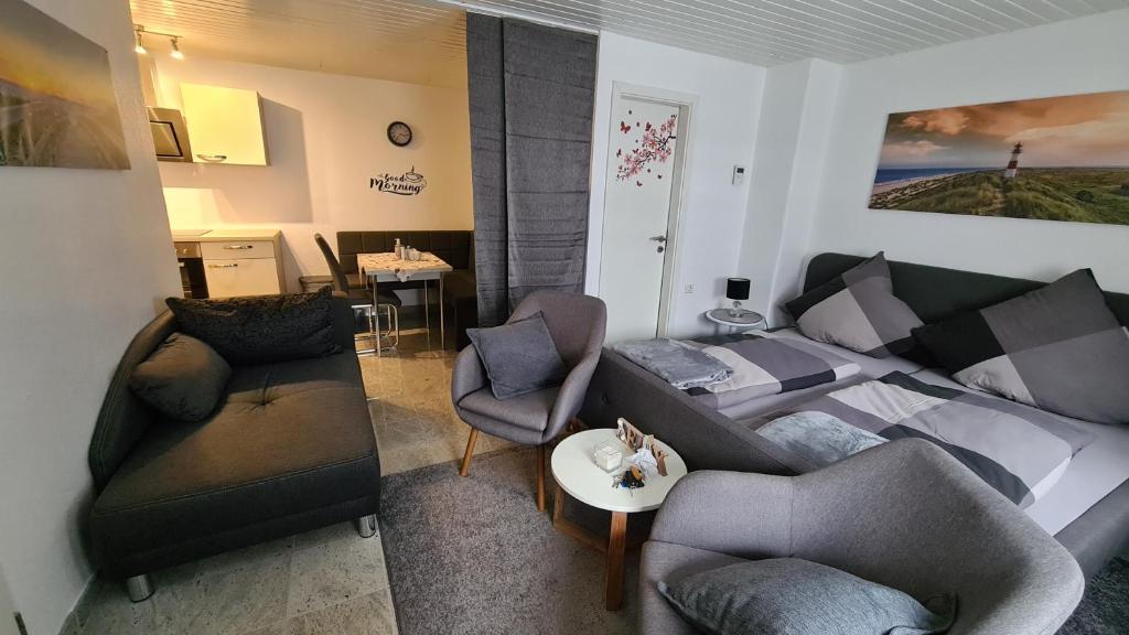 a living room with a couch and a bed at Ferienwohnung Thore in Emden